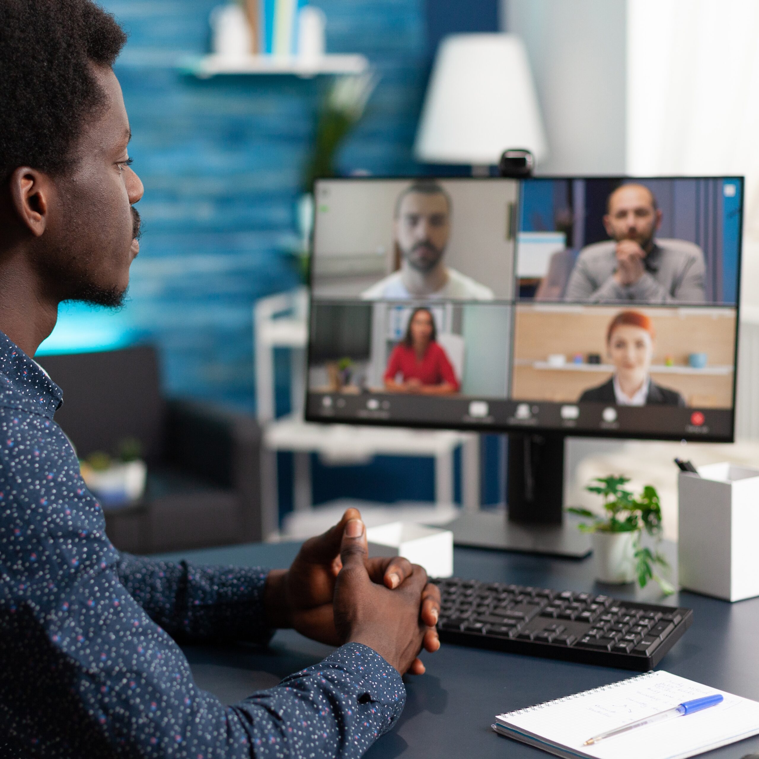 Man of african ethnicity using conference webcam communication to connect via internet with coworkers while working from home. Black person remote worker chatting about job duties
